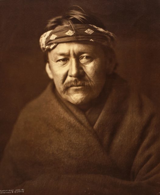 A Navajo man wearing blanket and headband