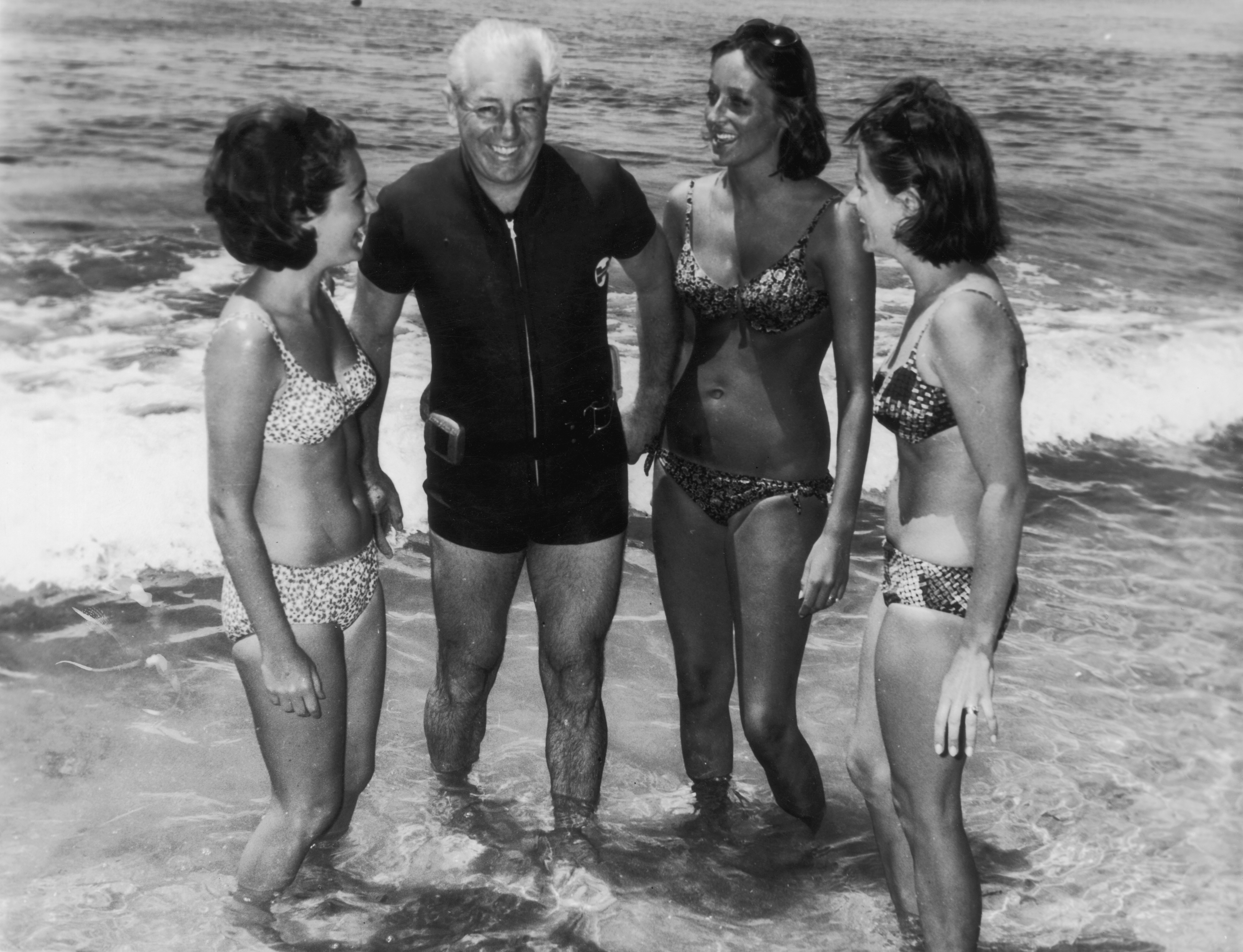 circa 1966:  Australian prime minister Harold Holt (1908 - 1967) on the beach with three women.  (Photo by Evening Standard/Getty Images)