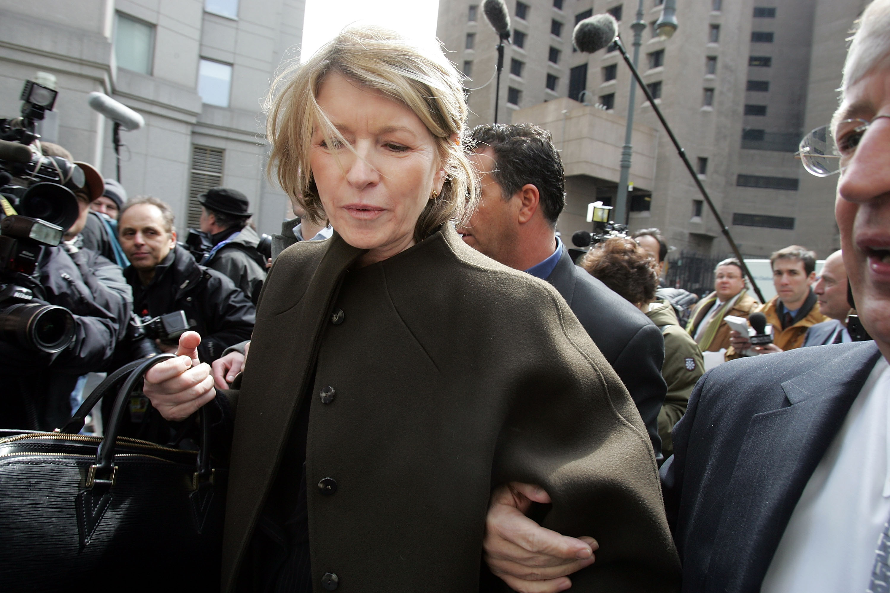 NEW YORK - MARCH 17:  Martha Stewart (L) makes her way through the media horde as she leaves the Federal Courthouse March 17, 2005 in New York City. Stewart appeared federal appeals court to argue that she was unfairly convicted on charges of lying about a stock sale.  (Photo by Mario Tama/Getty Images)