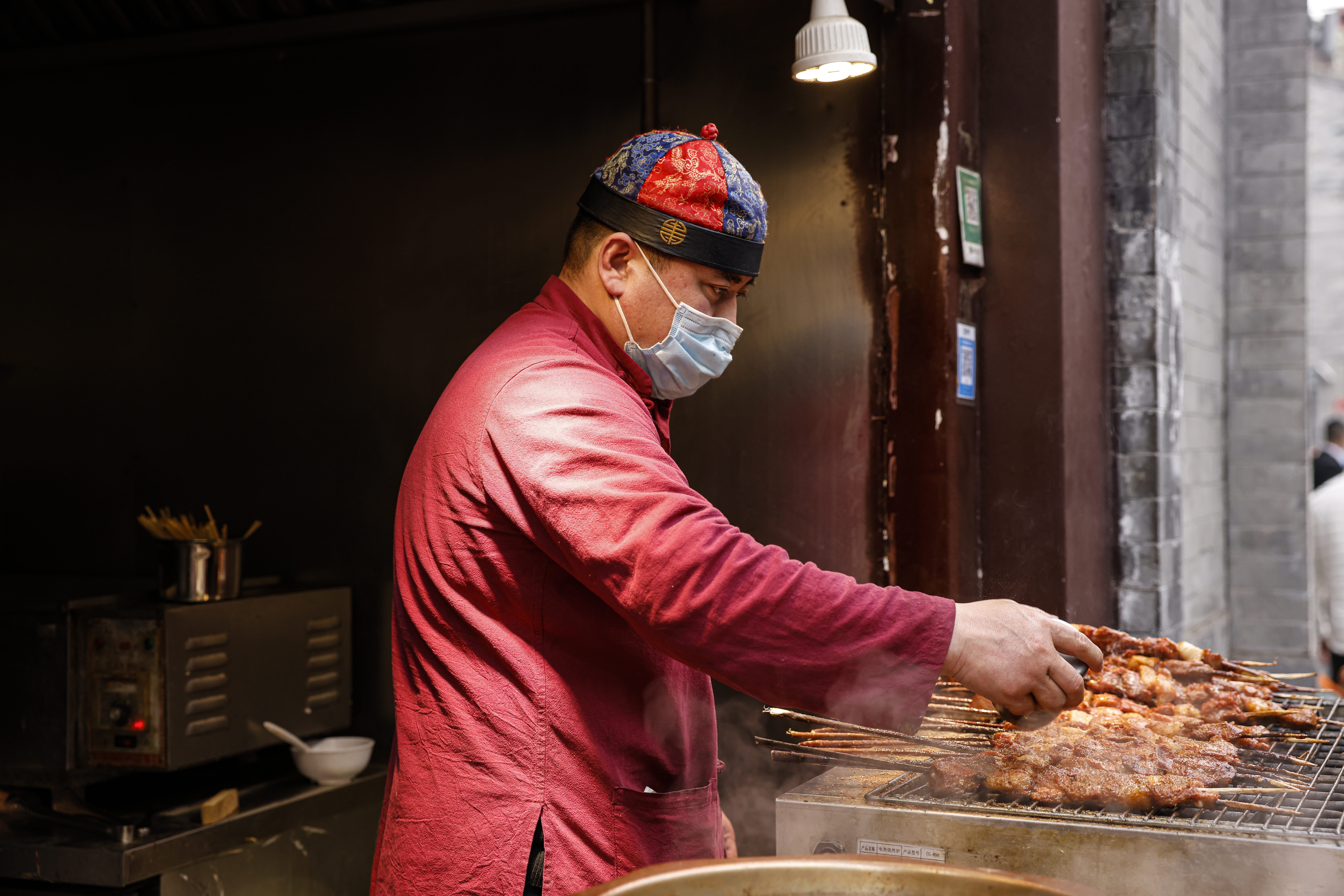 BEIJING, CHINA - FEBRUARY 12: Vendors sell mutton skewers at Qianmen Street ahead of Chinese New Year, the Year of the Ox, on February 12, 2021 in Beijing, China.(Photo by Fred Lee/Getty Images)