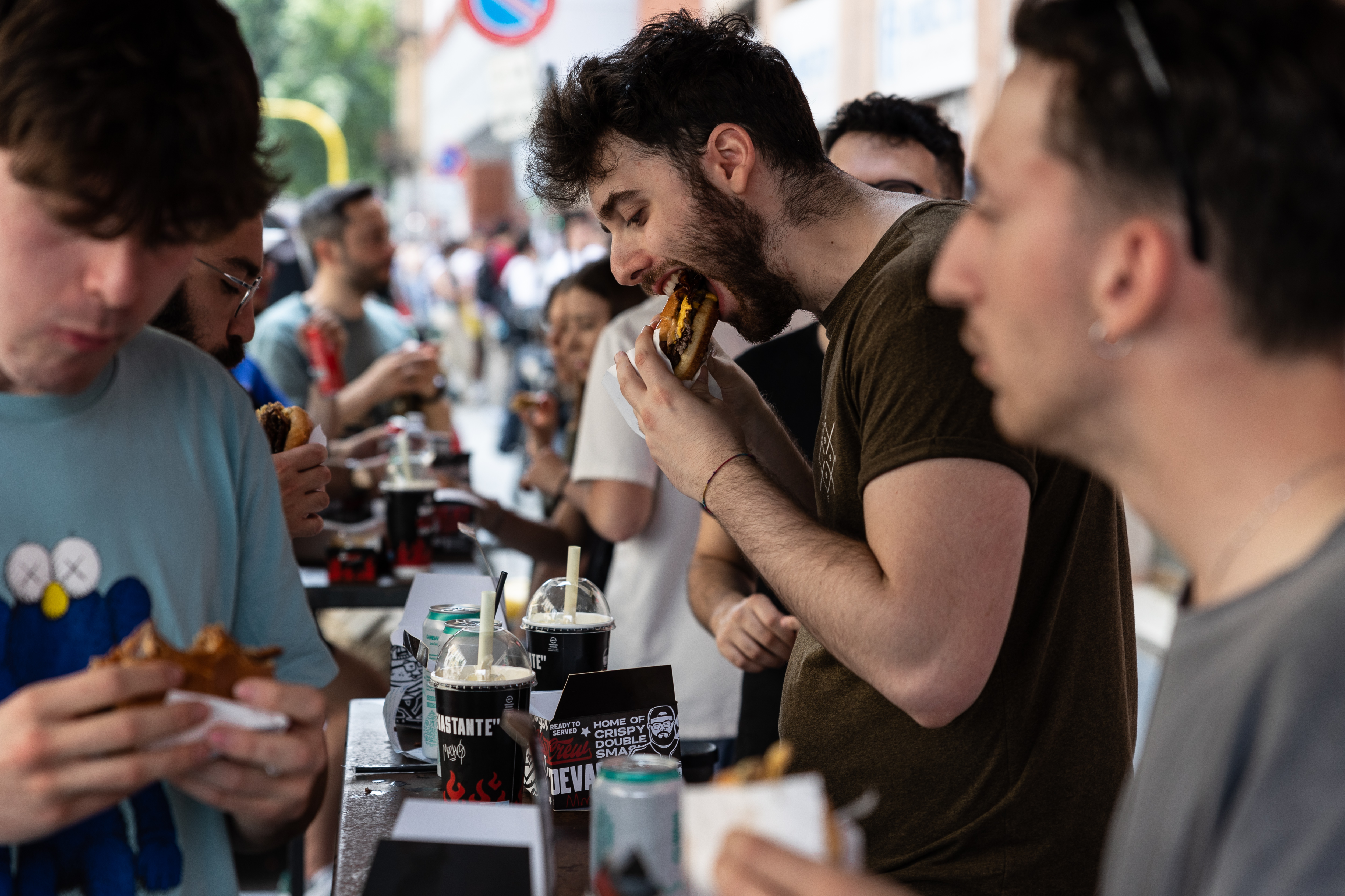 MILAN, ITALY - MAY 28: People eat hamburgers at Meat Crew fast food restaurant on May 28, 2023 in Milan, Italy. On occasion of the World Burger Day, celebrated on May 28 annually, Meat Crew gave away a free hamburger to 1,000 of its customers. (Photo by Emanuele Cremaschi/Getty Images)