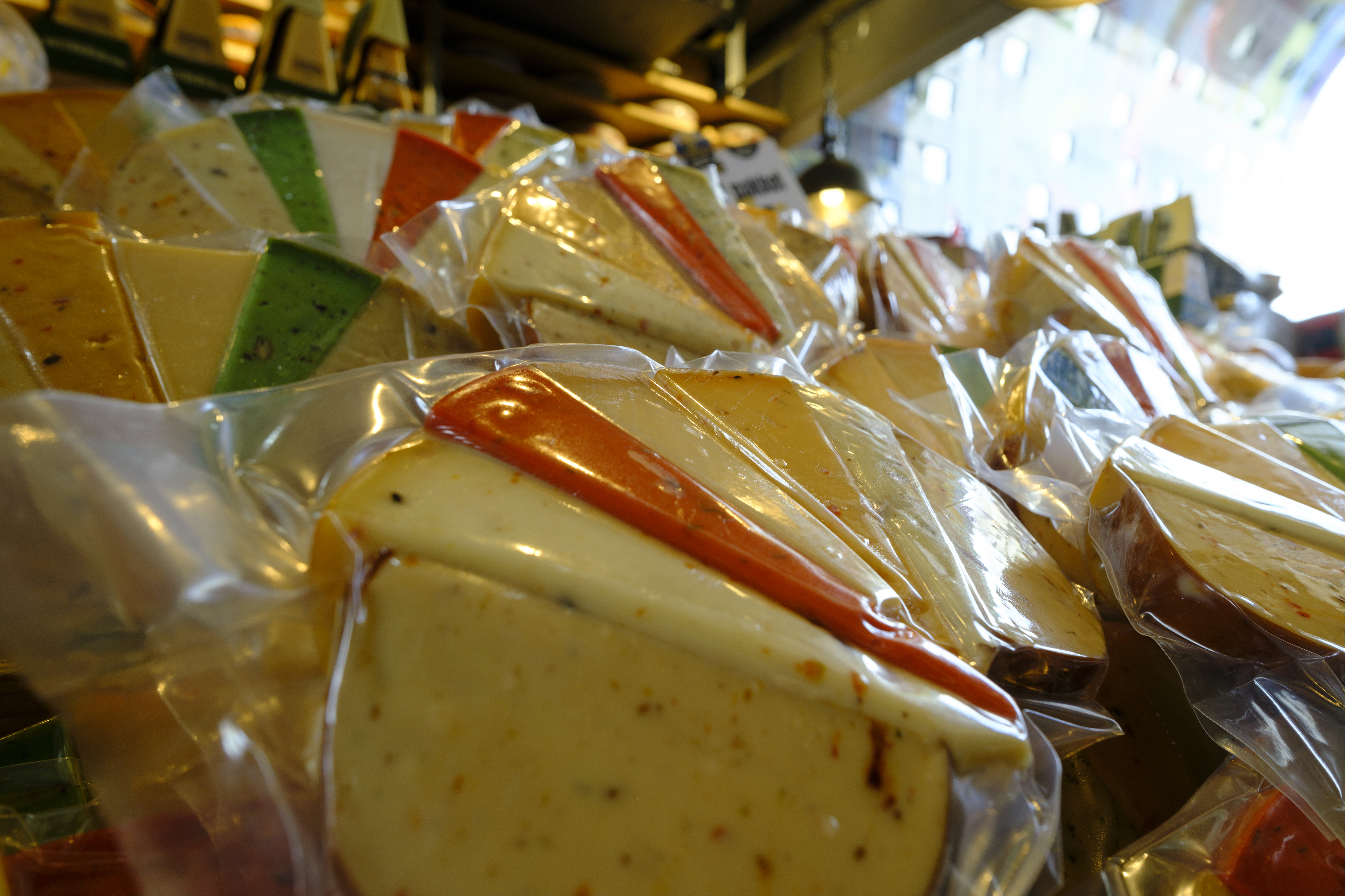 ROTTERDAM, NETHERLANDS - AUGUST 12: Gouda cheese are for sale in the  Market Hall on August 12, 2023 in Rotterdam, Netherlands. In the beguining of the XXI century, new European regulations set stricter requirements on selling produce such as fish, meat and cheese in the open air. In Rotterdam, this moment was seen as an opportunity, and on 19 November 2009 work began on a highly ambitious project: a fresh food market, the like of which the world had never seen. The first covered market in the Netherlands, the Market Hall, designed by architectural firm MVRDV, is a place where good food and unique housing are harmoniously combined in a spectacular arch. This iconic fresh market opened for business on 1 October 2014, after five years of construction. (Photo by Thierry Monasse/Getty Images)