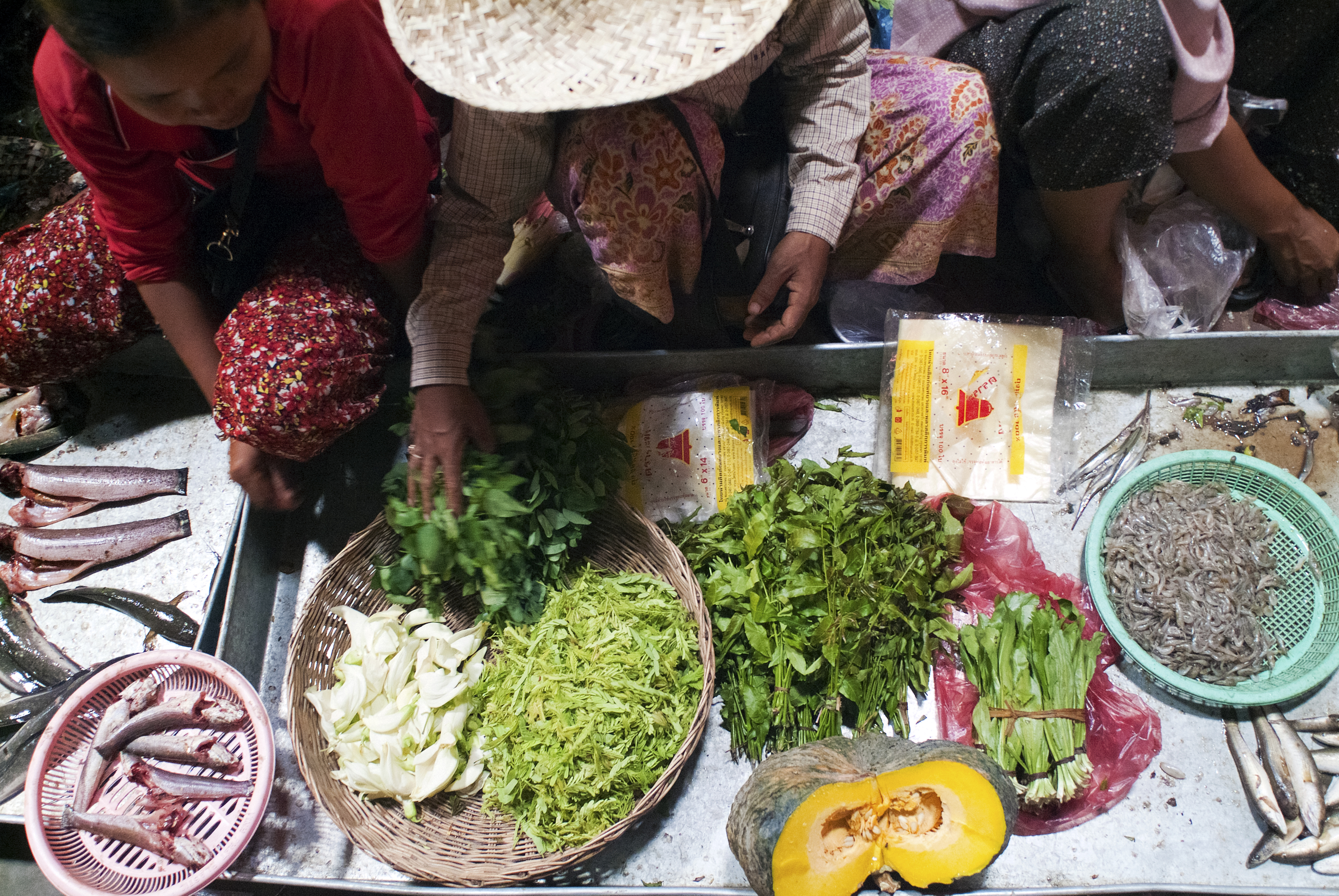 PSAR CHAA, SIEM REAP, CAMBODIA - 2010/09/24: Food vendors at Psar Chaa market in Siem Reap, a chaotic jumble of bodies and fresh produce plonked higgledy-piggledy under a tin shed in the centre of town. Alongside an assortment of fresh fruits and vegetables plus ready made dishes, there are dried river snakes , smoked fish, red ant eggs, bee larvae and a multitude of jars storing prahok, fermented fish paste. (Photo by Leisa Tyler/LightRocket via Getty Images)