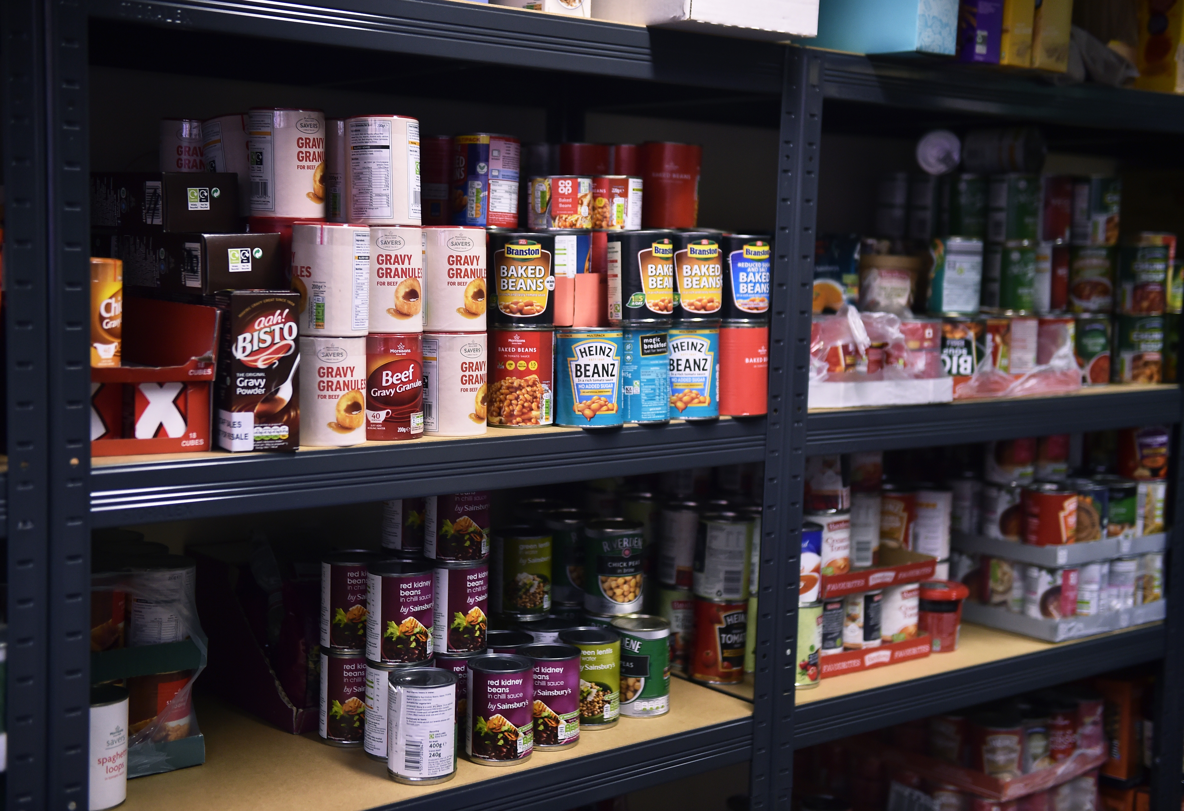 NEWCASTLE-UNDER-LYME, ENGLAND - JANUARY 15: Tins of food are left on the shelves at the Tri Service Support Centre food bank on January 15, 2021 in Newcastle-under-Lyme, England. Early in 2020 the armed forces charity SSAFA, in collaboration with the Tri Service Support Centre in Newcastle-under-Lyme, created a bespoke foodbank for military veterans living in the the town. Every Saturday tinned goods, fruit, vegetables, dried food and snacks donated by local supermarkets via FareShare, a charity determined not to let food go to waste, is bagged up by volunteers and distributed.  This service came into its own at the start of the Covid-19 pandemic when the service was extended to any person or family in need as well as veterans and they have since handed out over 100,000 food parcels. (Photo by Nathan Stirk/Getty Images)