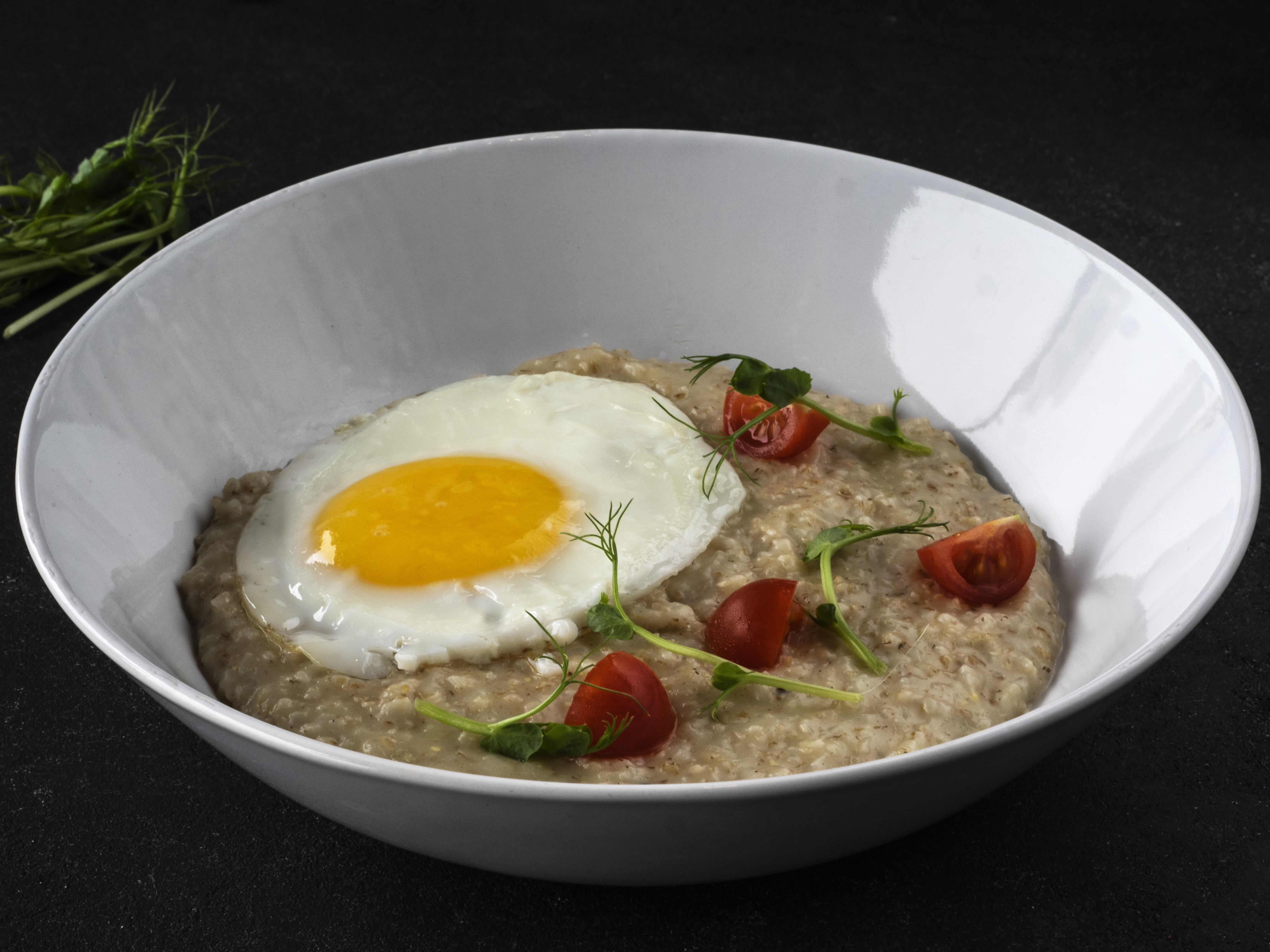 KIEV, UKRAINE - 2019/01/28: Parmesan Oatmeal and Scrambled Eggs seen served on a plate. (Photo by Igor Golovniov/SOPA Images/LightRocket via Getty Images)