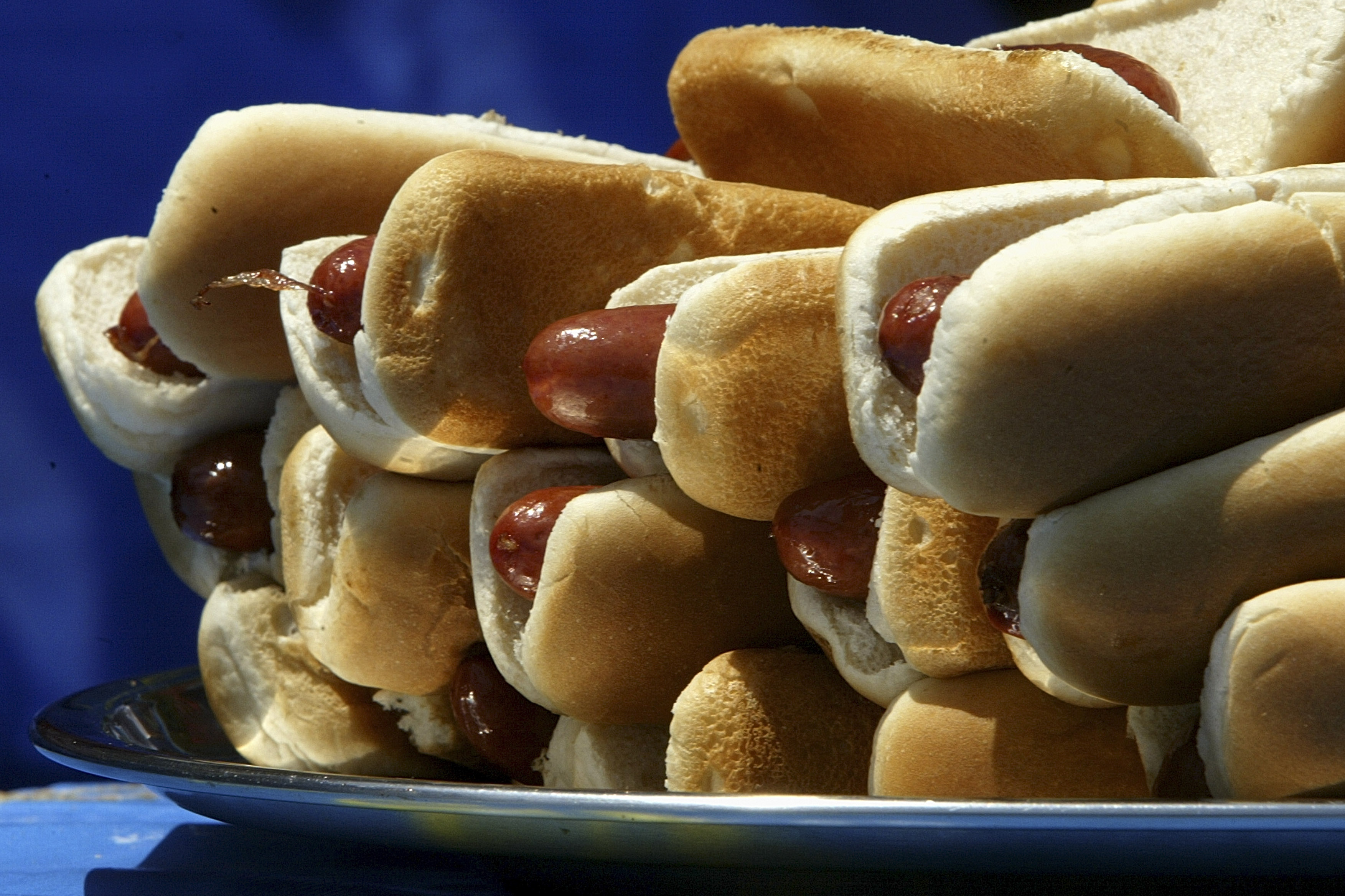 NEW YORK - JULY 4: A plate of hot dogs sit on a table at the annual Fourth of July International Hot Dog Eating Contest at Coney Island July 4, 2005 in the Brooklyn borough of New York City. Kobayashi won for the fifth year in a row eating 49 hotdogs in 12 minutes. (Photo by David Paul Morris/Getty Images)