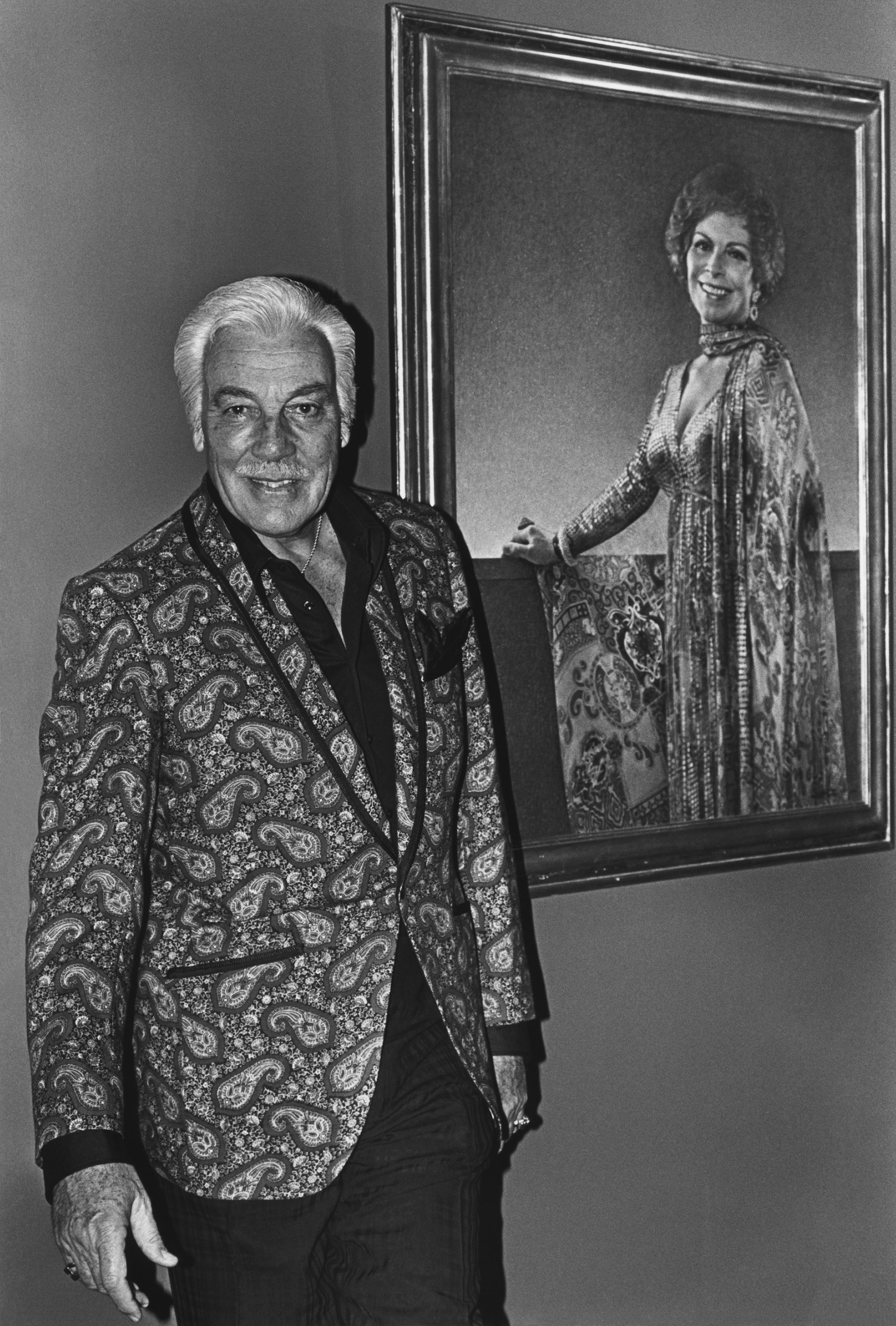 BEVERLY HILLS, CA - 1979:  Hollywood film and TV actor Cesar Romero poses in the foyer of his home in Beverly Hills, California. Romero was perhaps best known for his role as 
