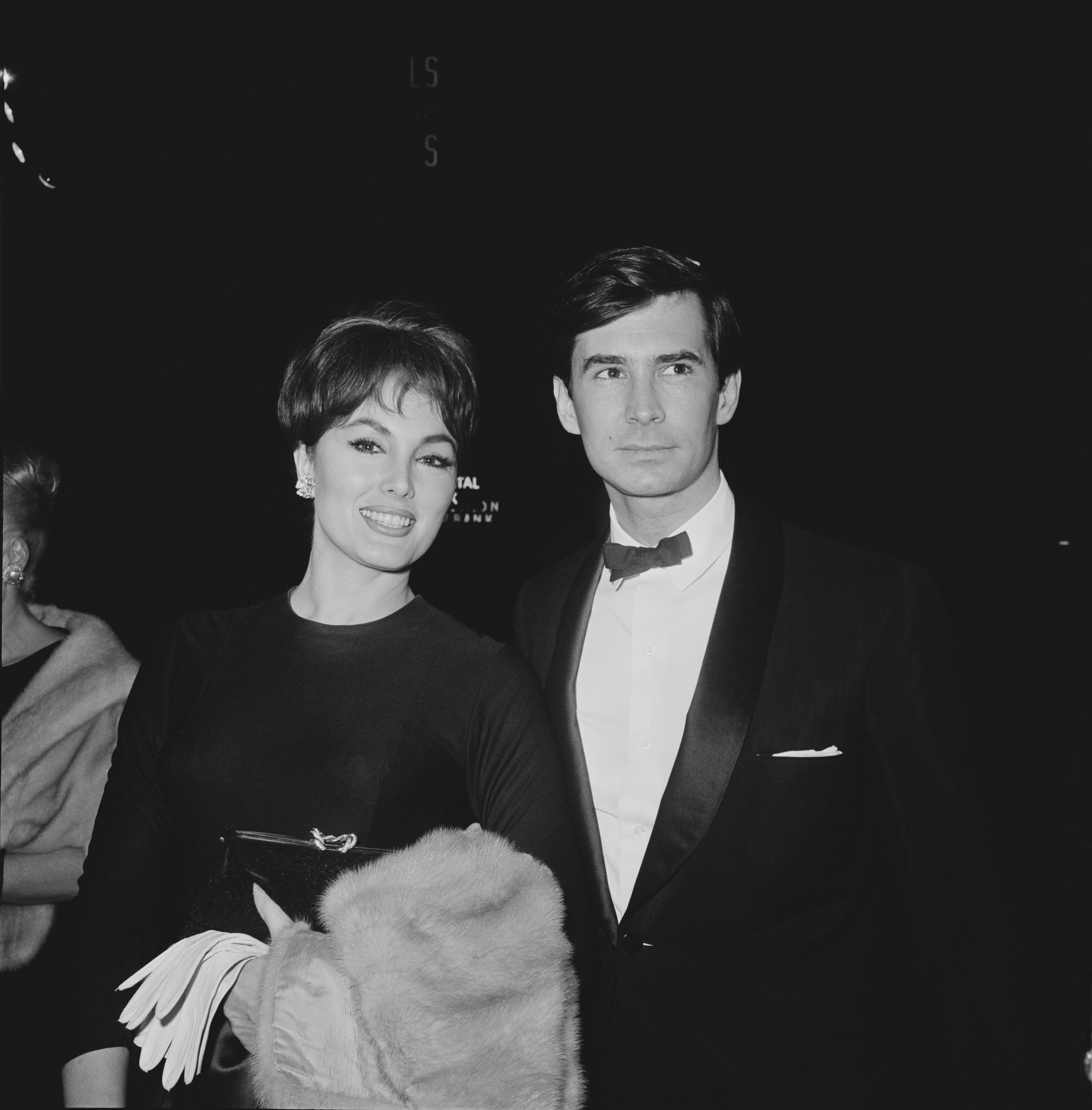 American actor and singer Anthony Perkins (1932 - 1991) with American actress Charlene Holt at the premiere of