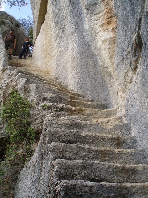 Secret staircase carved in the rock of Fort de Buoux Photo Credit
