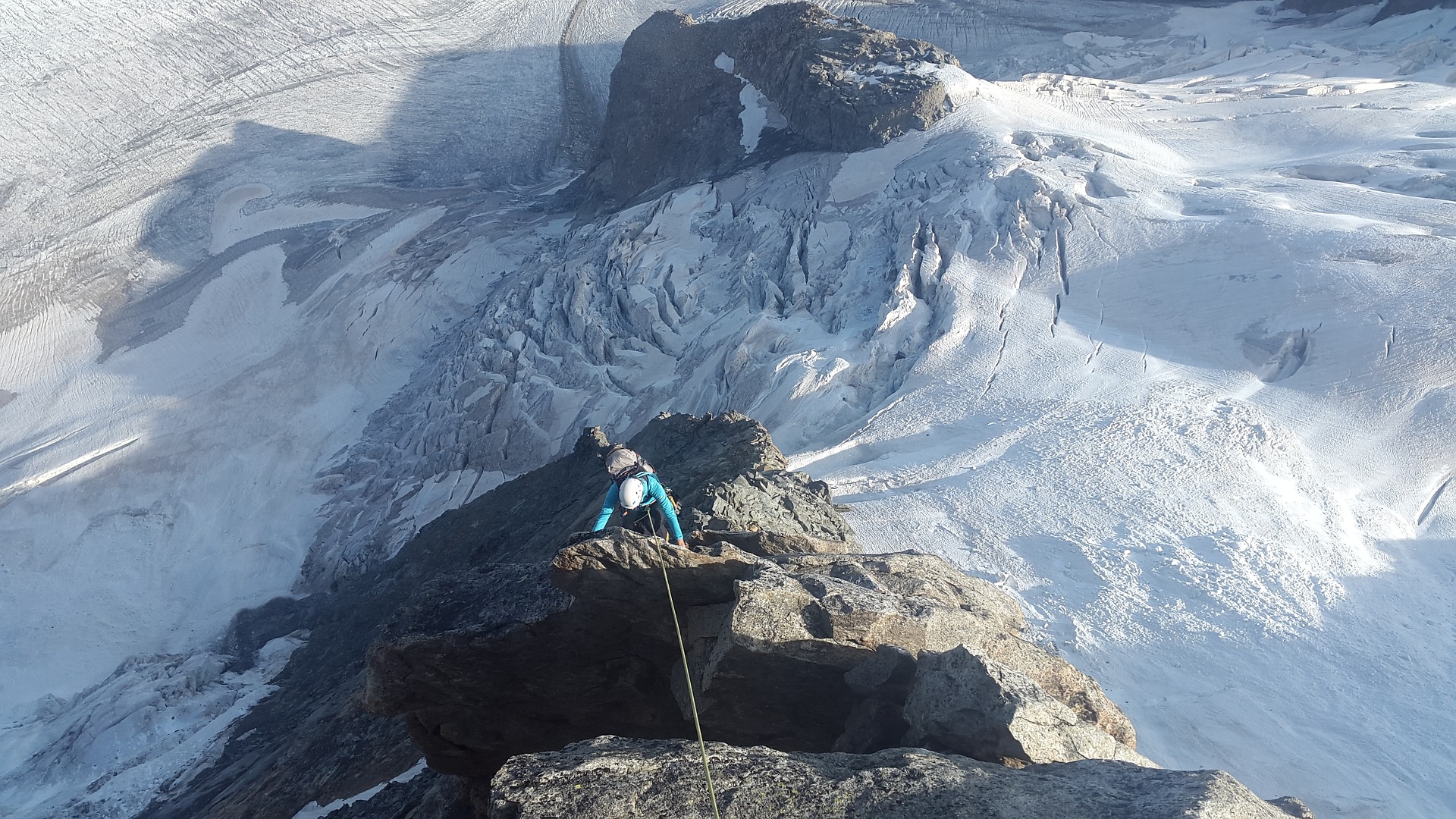 High alpine climbing wearing a rock climbing helmet