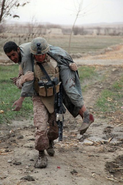A US Marine carrying an injured man.