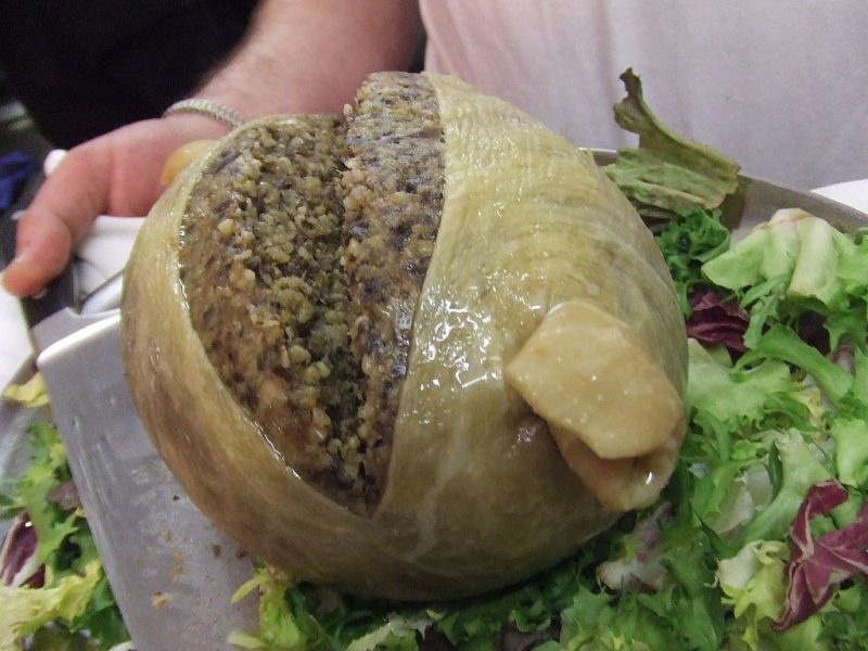 Haggis is a savory pudding containing sheep’s pluck (heart, liver and lungs), minced with onion, oatmeal, suet, spices, and salt, mixed with stock, traditionally encased in the animal’s stomach though now often in an artificial casing instead. – Author: Tess Watson – CC BY 2.0