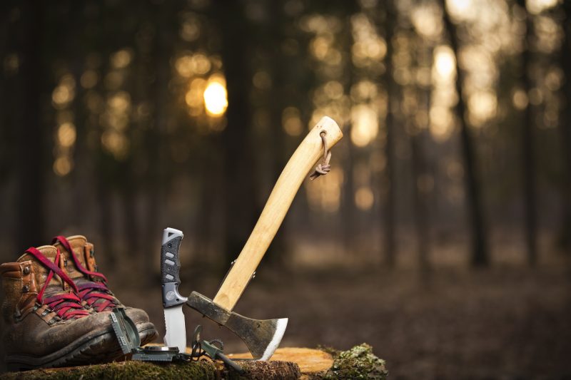 An axe, a knife, and a good pair of boots are the basic camping survival tools.
