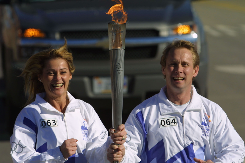 nadia comaneci and bart conner olympic torch