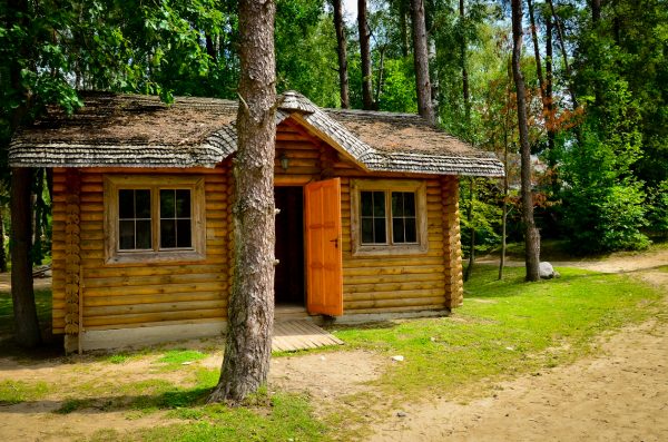 A little rustic log cabin in the woods on a sunny day is an idyllic experience that many people want to have.