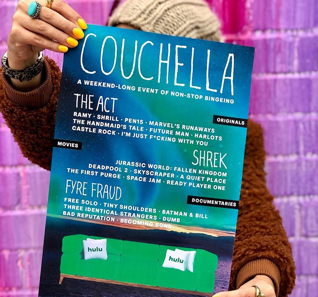 an ad for hulu of a woman holding up a couchella sign 