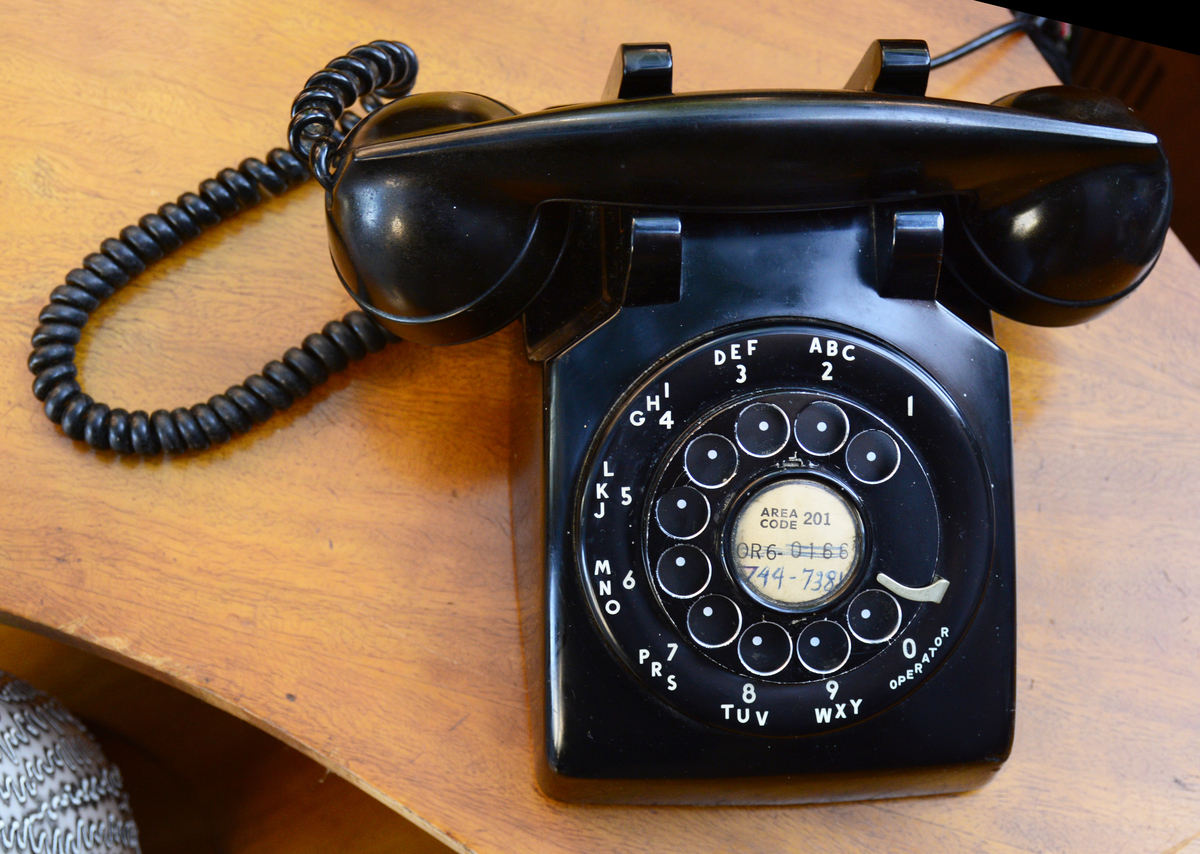 A vintage rotary dial telephone for sale at a flea market 