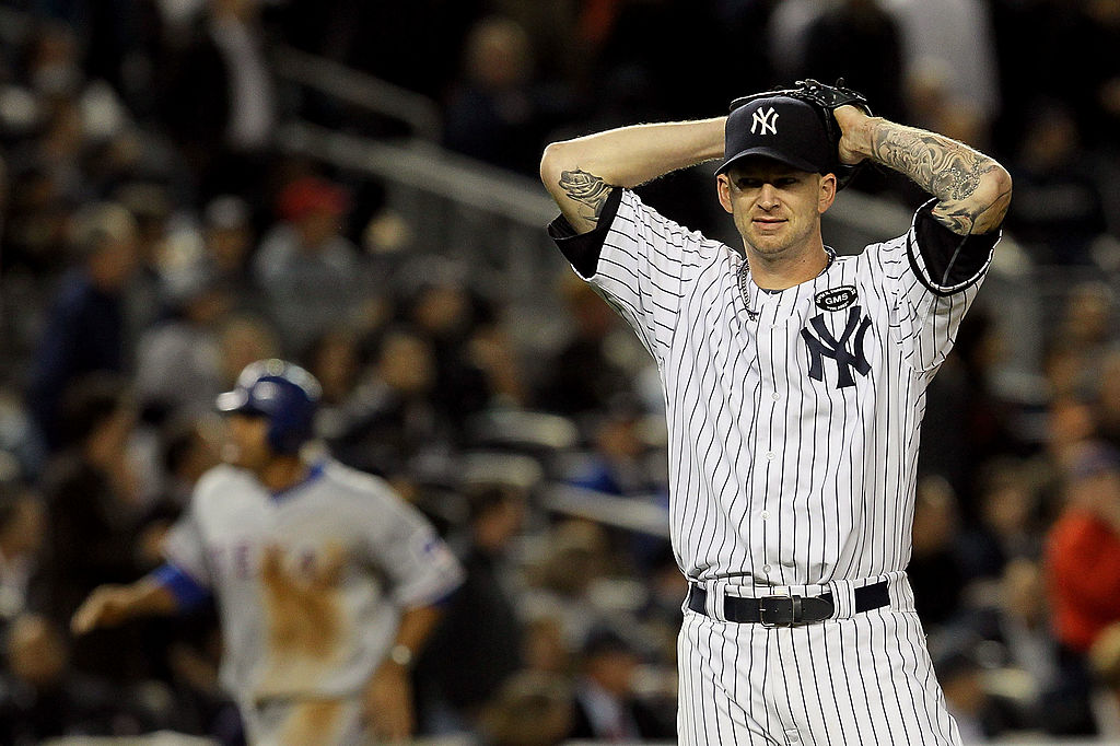 A.J. Burnett #34 of the New York Yankees reacts after giving up a three-run home run to Bengie Molina #11 of the Texas Rangers in the top of the sixth inning in Game Four of the ALCS during the 2010 MLB Playoffs at Yankee Stadium on October 19, 2010 in the Bronx borough of New York City-105756481