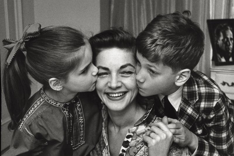 The American actress Lauren Bacall fondly plays with her children Leslie and Stephen