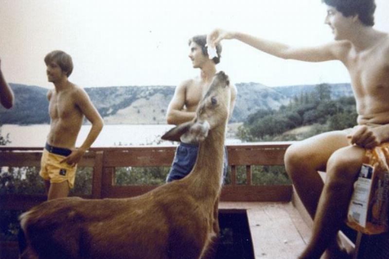 John Warlow feeding a deer at the cabin in Copco Lake, CA