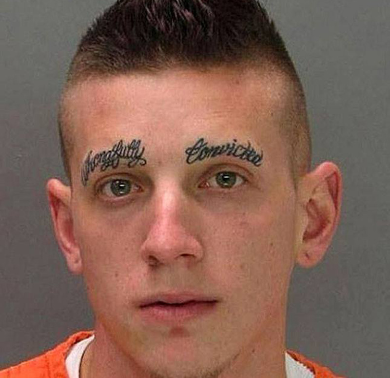 a mugshot of a man with tattooed eyebrows