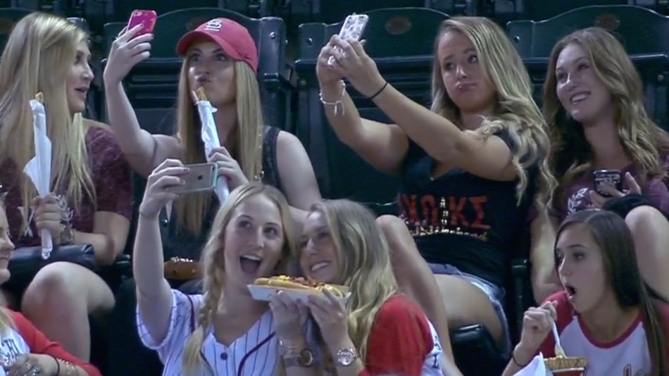 sorority girls taking selfies at baseball game