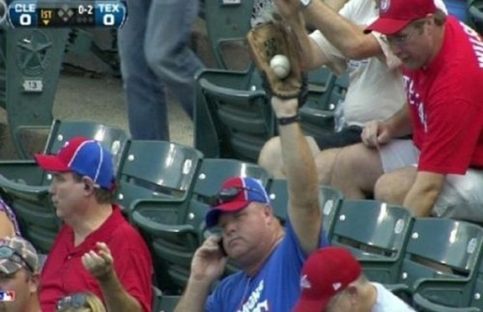 fan on the phone while catching a foul ball