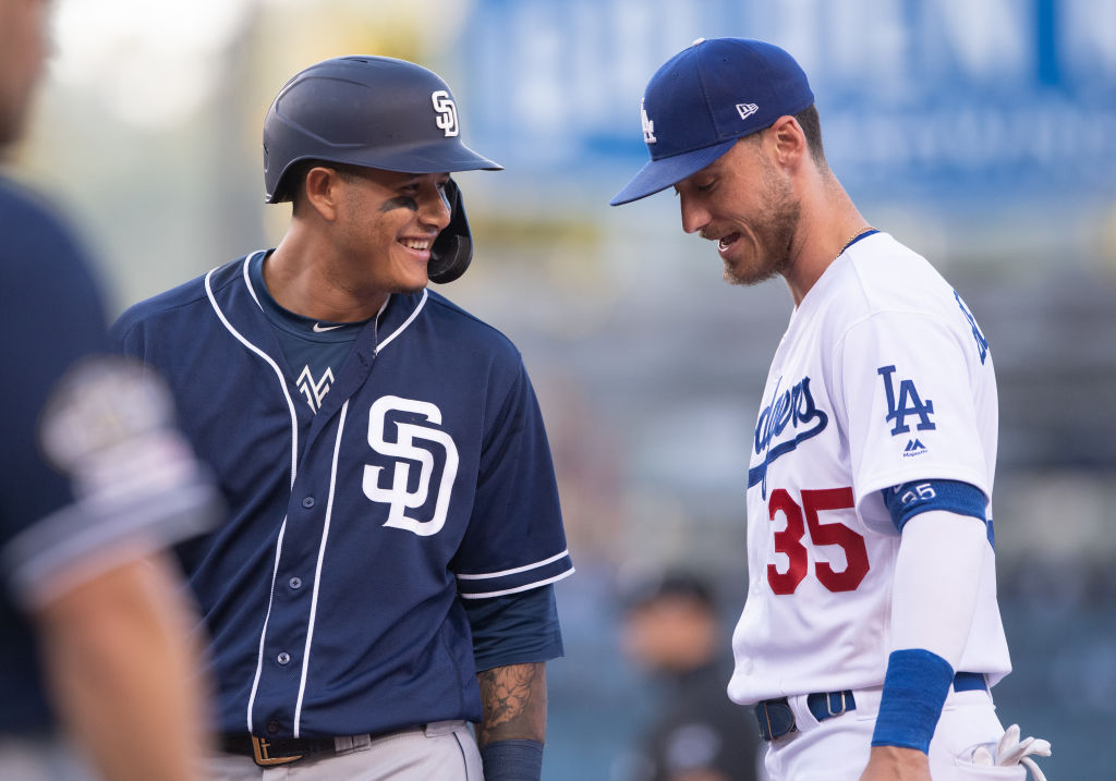 San Diego Padres Third base Manny Machado (13) smiles as he talks to Los Angeles Dodgers Right field Cody Bellinger