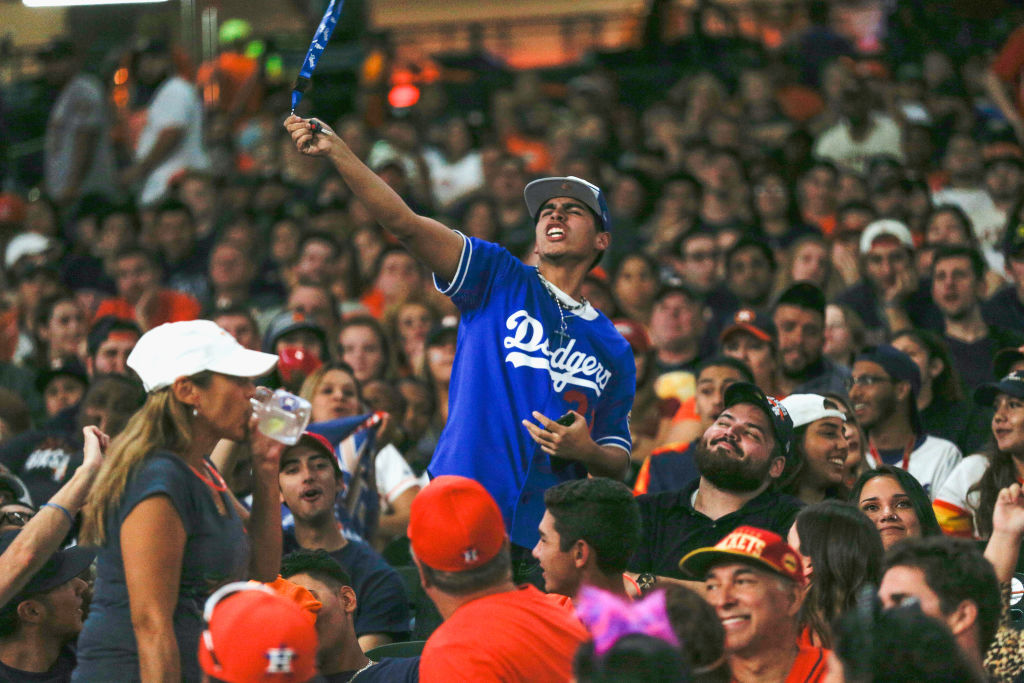 A Los Angeles Dodgers fan cheers amongst the Astros fans during the Houston Astros World Series