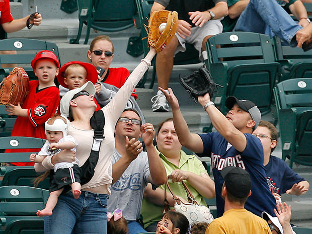 mom catches foul ball with baby in hand