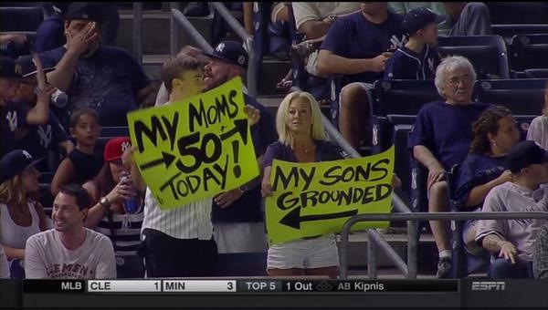 fans with signs at a baseball game