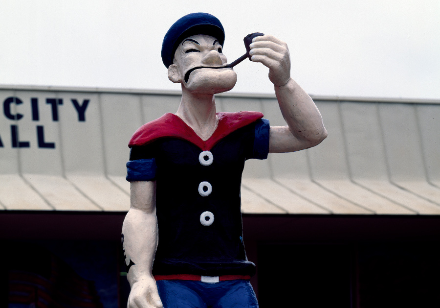 a statue of popeye smoking a pipe