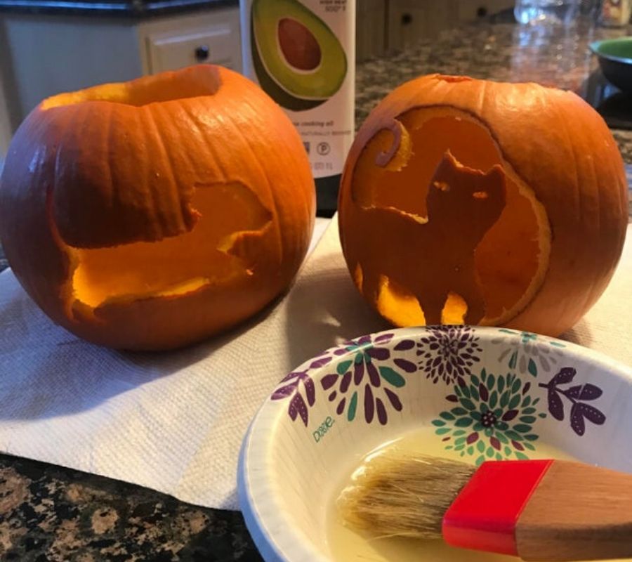 carved pumpkins being brushed with oil
