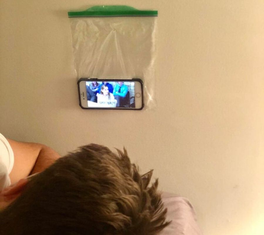 someone put their phone in a plastic bag tacked to the wall so they could watch a movie