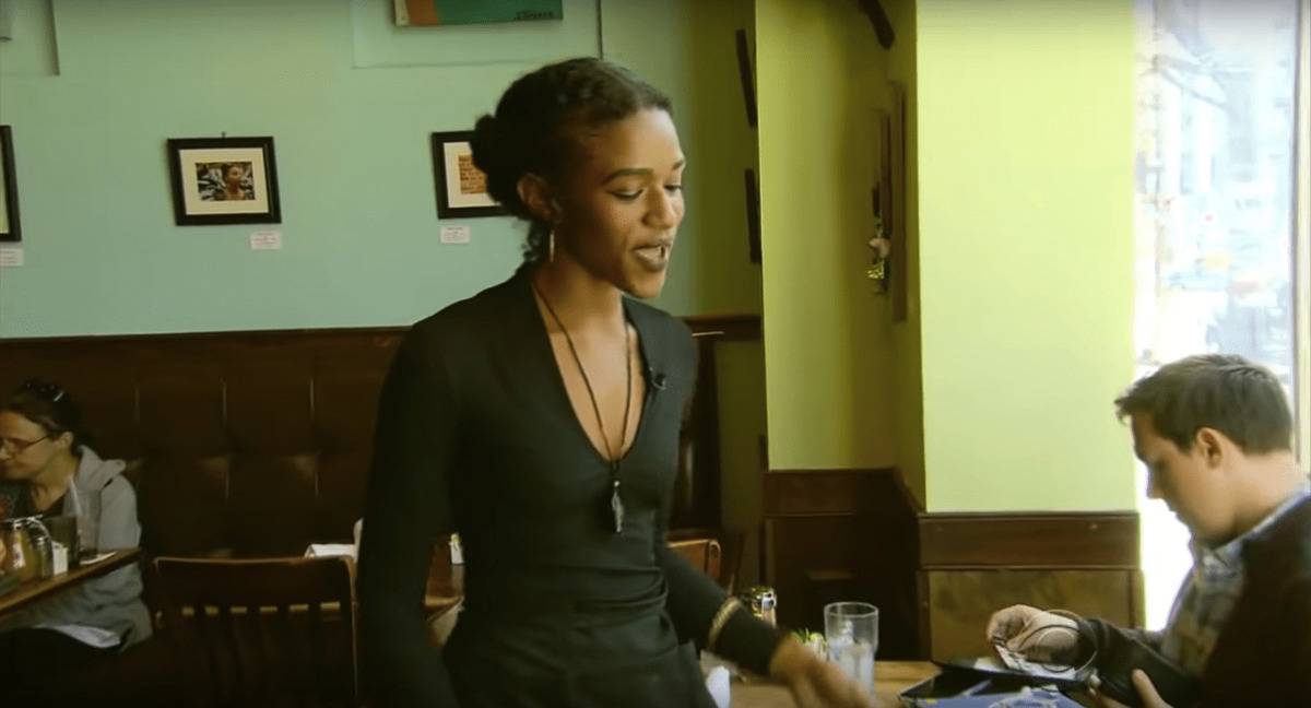 waitress smiling as she serves customer