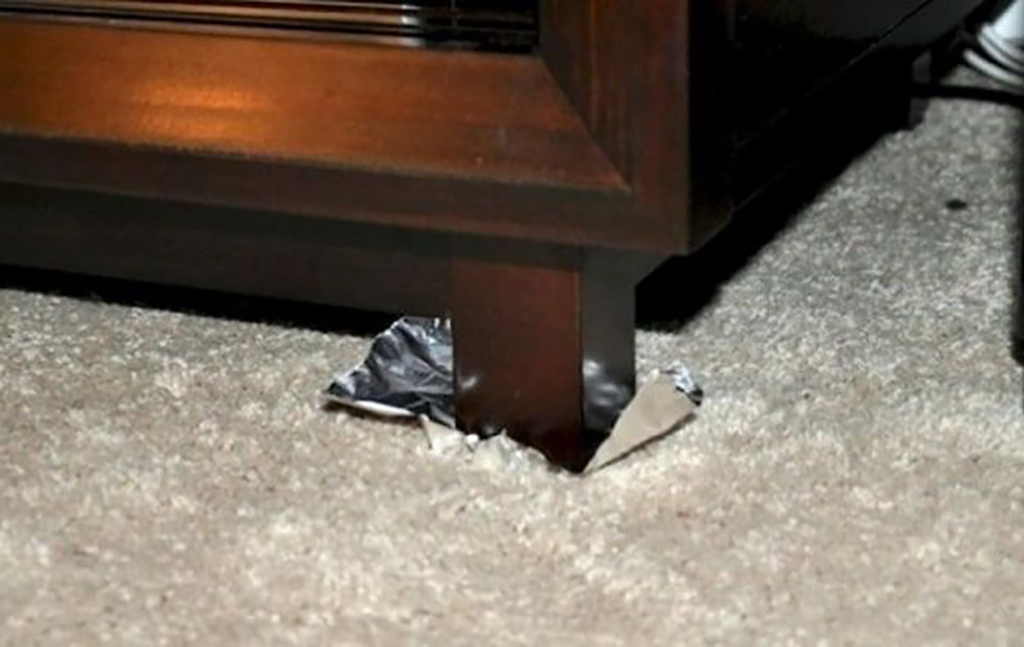Piece of foil underneath furniture leg 