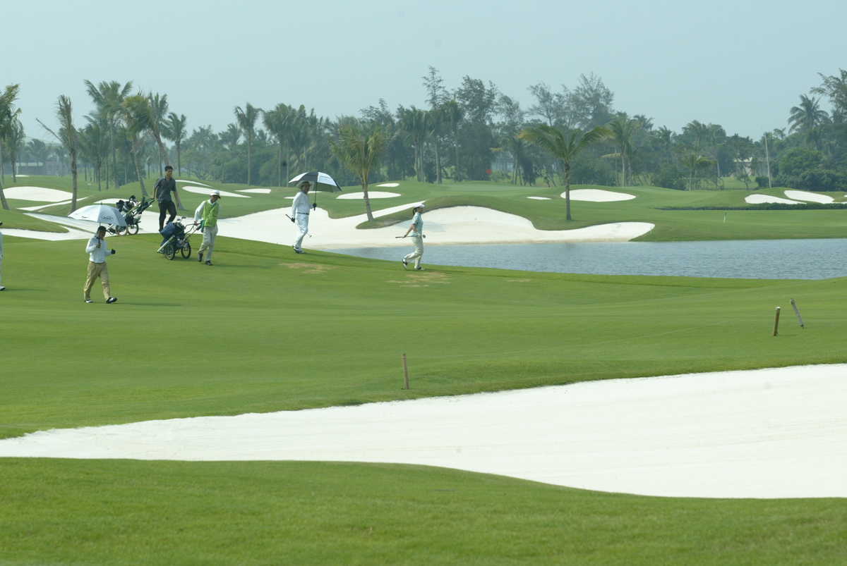 Golfers walk through a course in Hainan.