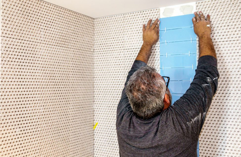 Man installing bathroom tile 