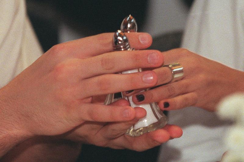 People pass salt shakers during an etiquette class.