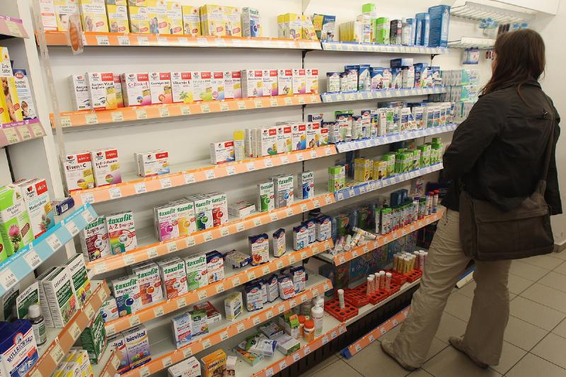 A shopper looks among health supplements at a drugstore.
