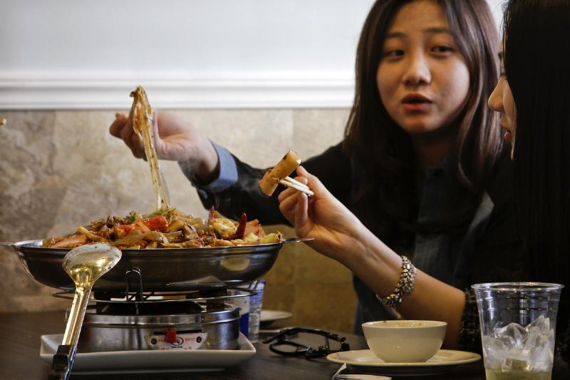 Customers eat lunch at Tasty Dining, a Chinese style restaurant.