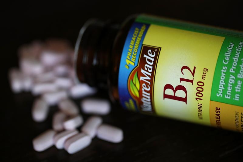 A spilled bottle of vitamins B12 pills is displayed.