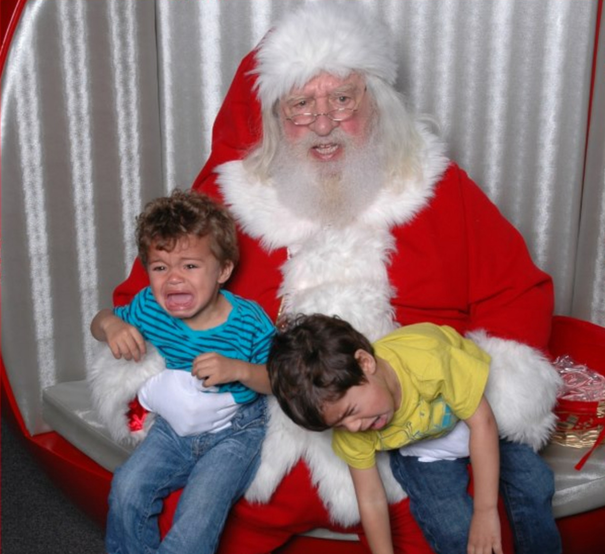 two boys sobbing during photo with santa