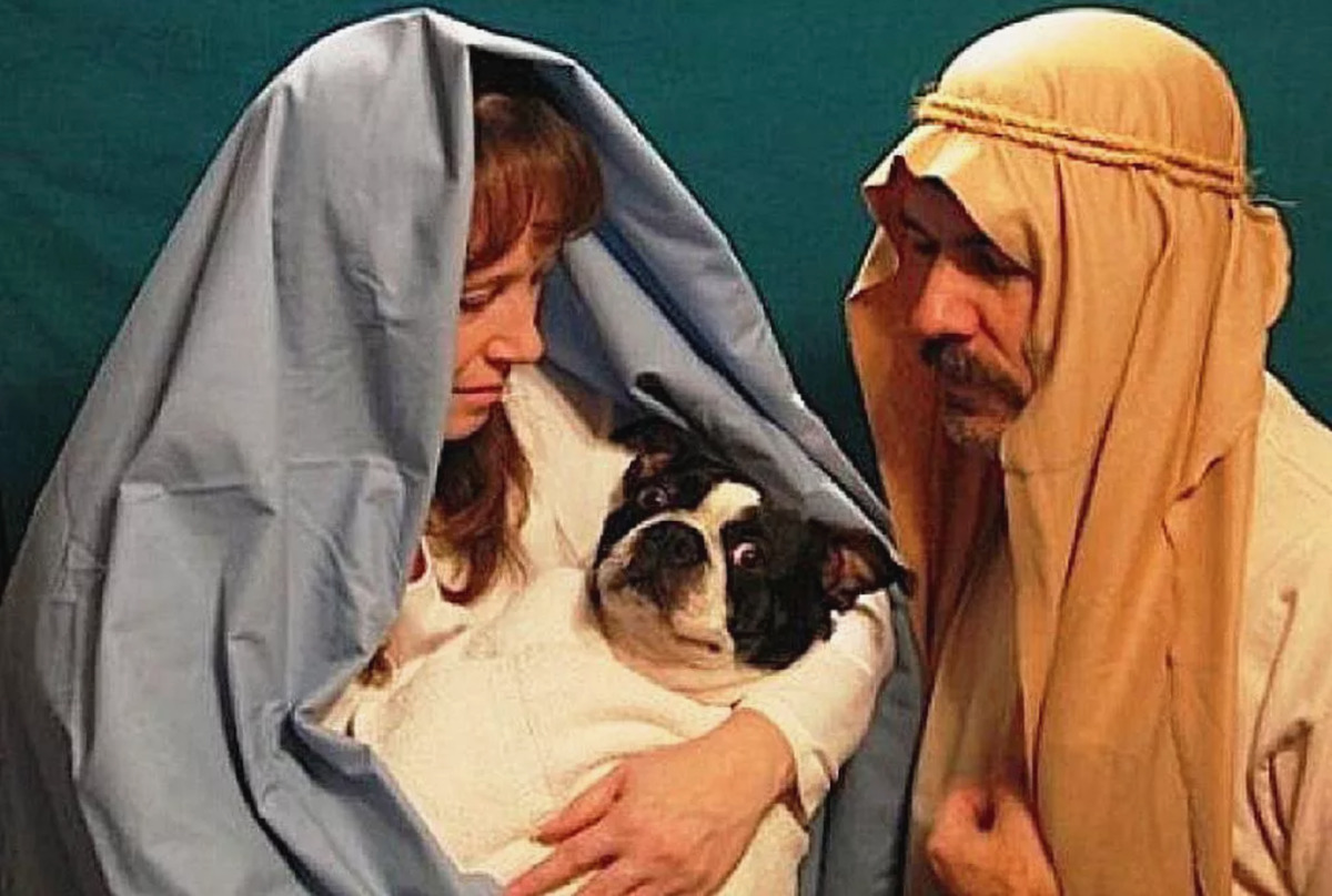 couple dressed as mary and joseph while dog is jesus
