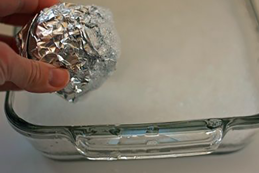 Ball of aluminum foil used to scrape dish 