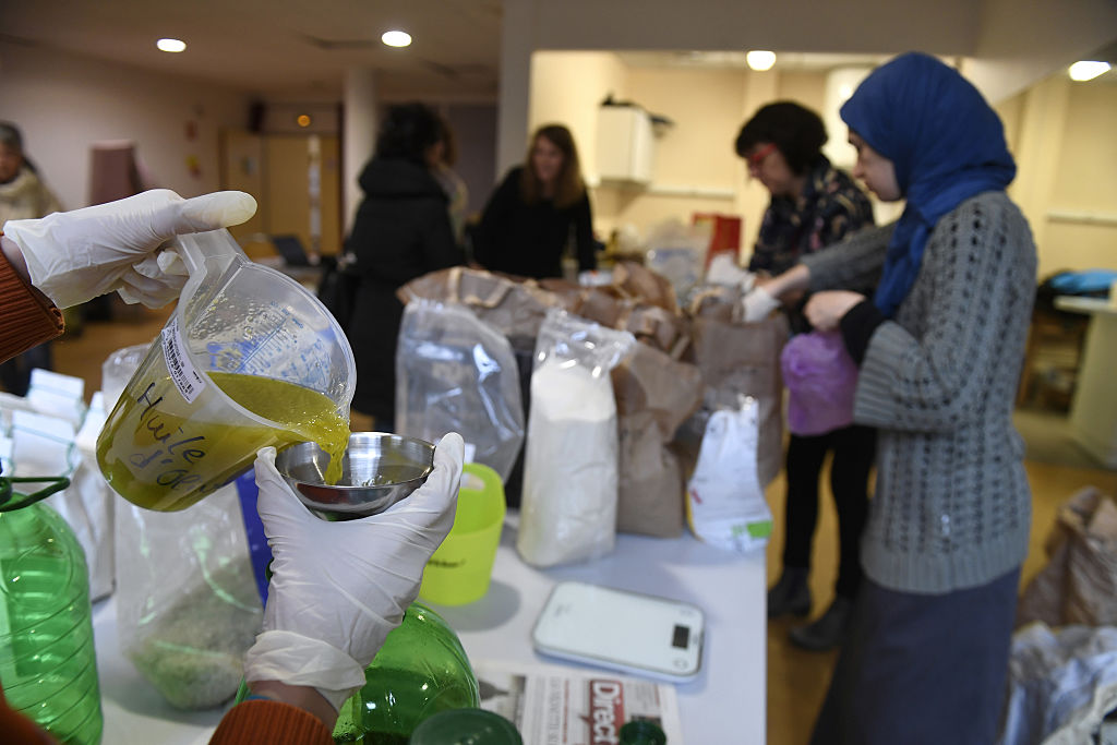 someone pouring cooking oil into a small bowl