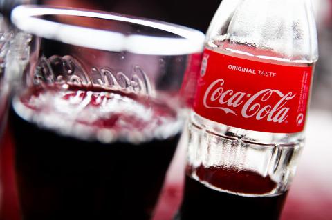 a glass and bottle of coca-cola