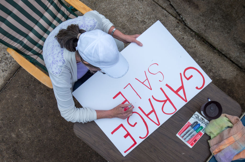 A woman makes a sign that reads 