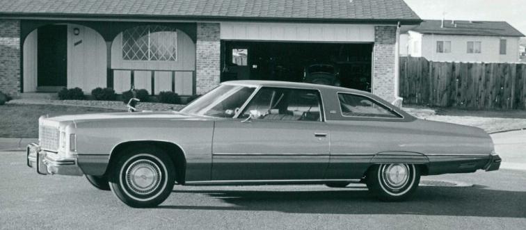 Car on street in front of house 