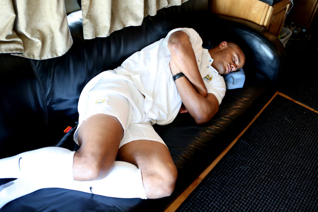 A man sleeps on a couch.